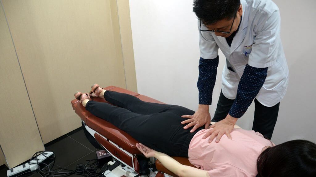 Chiropractor treating patient for back pain