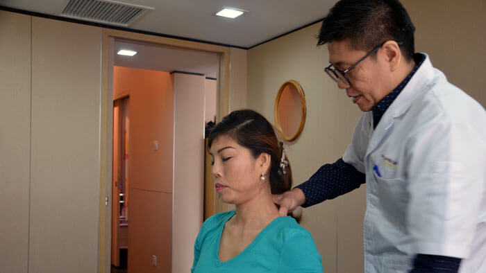 Doctor providing patient chiropractic treatment for headaches, migraine, and dizziness