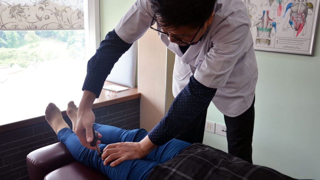 Chiropractor treating patient for joint pain or subluxation