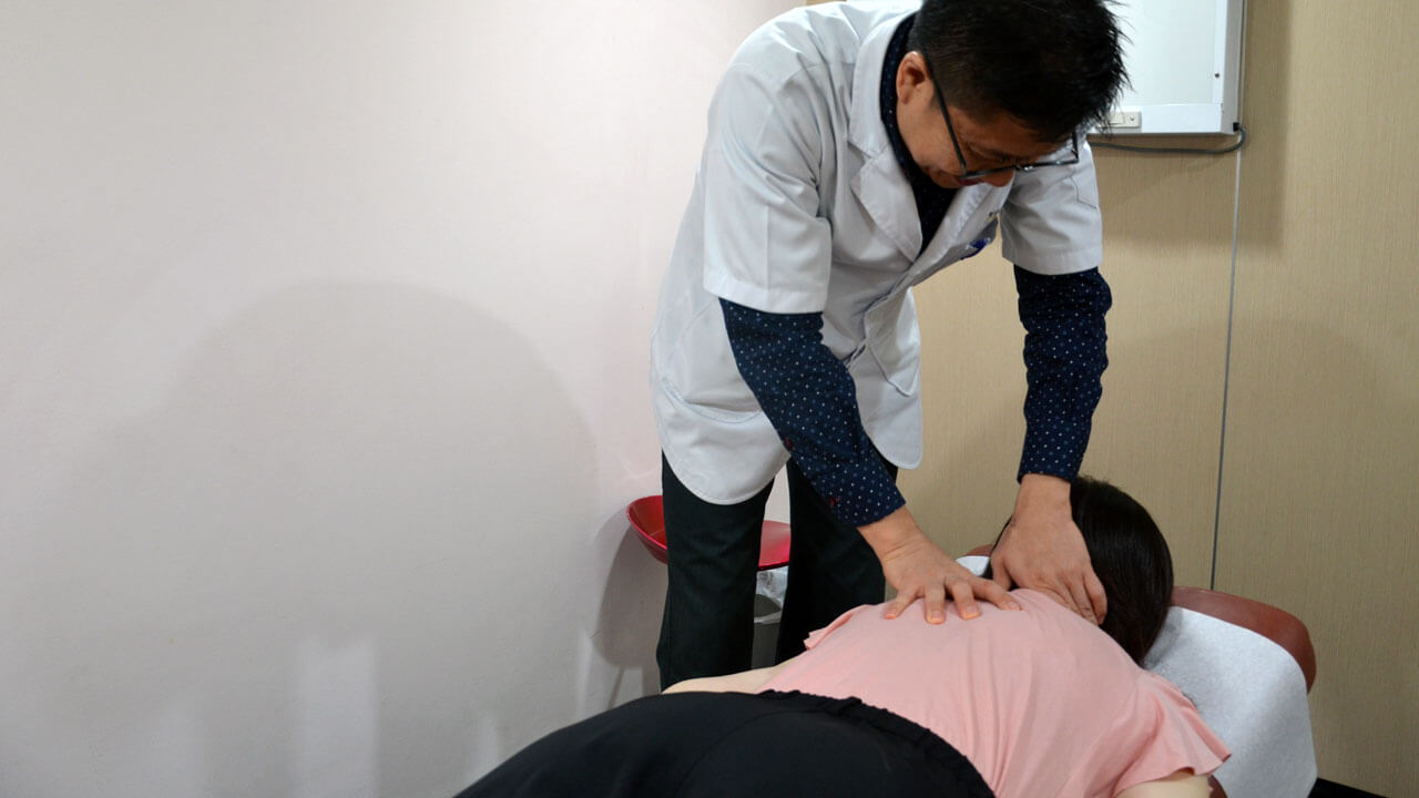 Chiropractor treating patient for neck pain