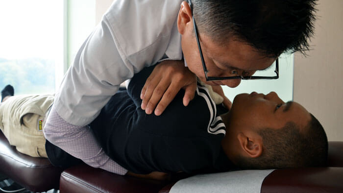 Chiropractor providing patient herniated disc treatment