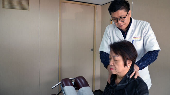 Doctor providing patient neck pain chiropractic care